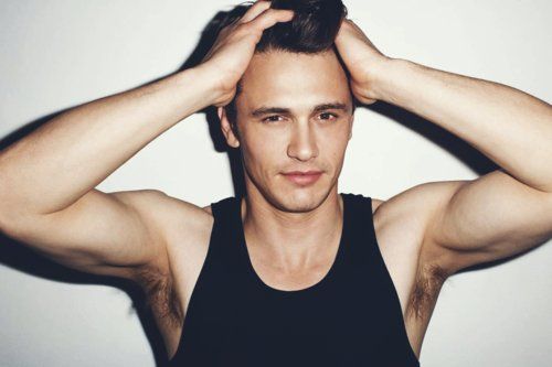 sexiest man alive james franco with his hands on his head in a tank top looking so hot