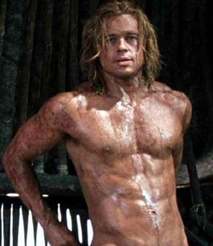 celebrity brad pitt with long hair showing off his 6 pack and all muddy