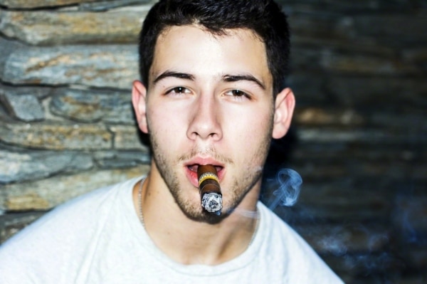 Nick Jonas with cigar in his mouth