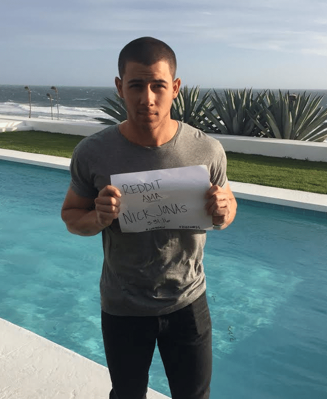 Nick Jonas with piece of paper saying he is on reddit