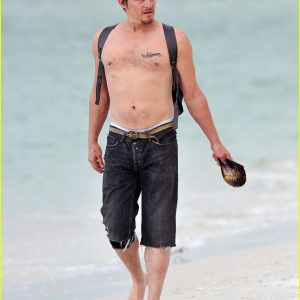 sexy norman reedus with his shirt off at the beach and in jean shorts