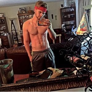 hottie kenton duty in basketball shorts with no shirt on and a sweat head band on