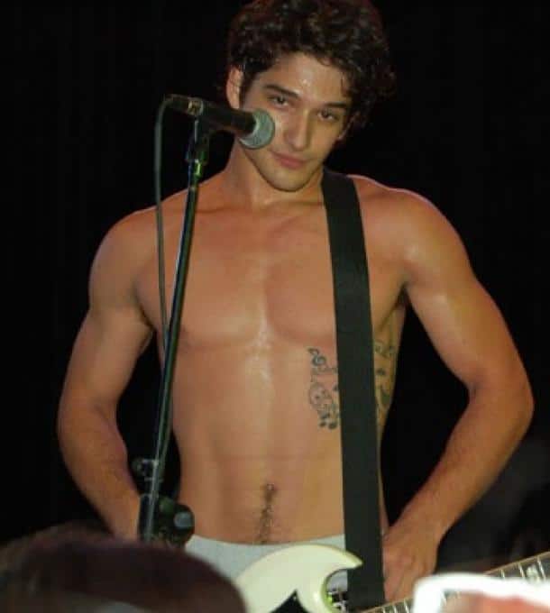 actor Tyler Posey shirtless on stage showing off his 6 pack