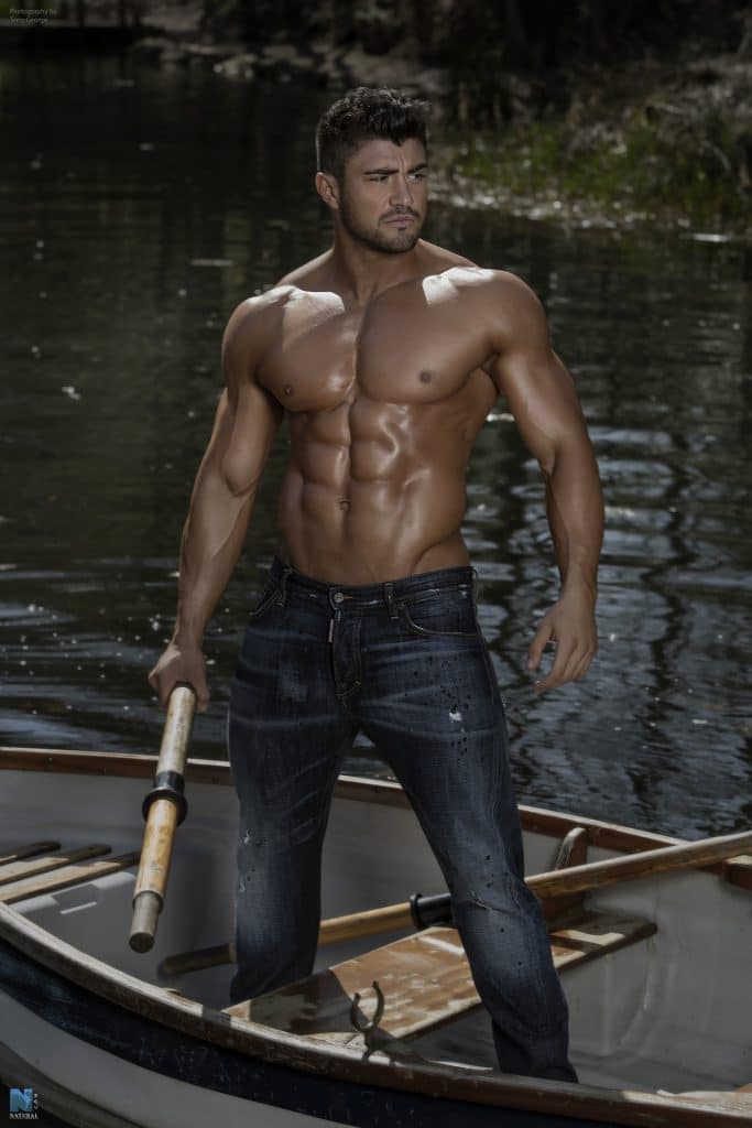 Rogan O'Connor shirtless in a canoe